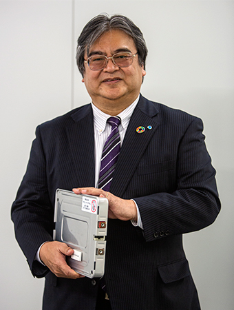 Eiji Makino, holding a module 