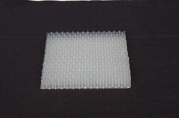 Nissan's acoustic meta-material, a white plastic sheet on a black surface