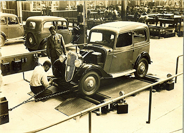 old photo of a car being assembled